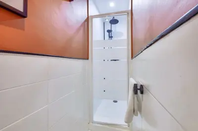 a bathroom with a shower with a mirror at Lovely 1 BR Flat in the heart of Nice in Nice