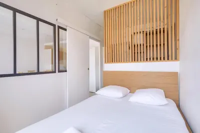 a bedroom with a white bed with two pillows at Lovely 1 BR Flat in the heart of Nice in Nice