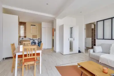a living room with a table and a couch at Lovely 1 BR Flat in the heart of Nice in Nice