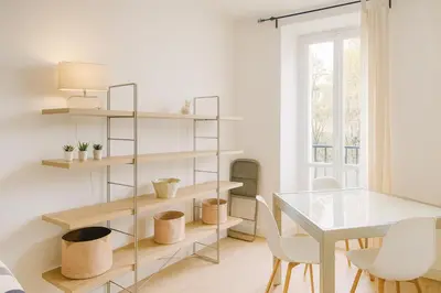 a dining room with a table and shelves at Cassini 2 Pers Hyper Center WiFi in Nice