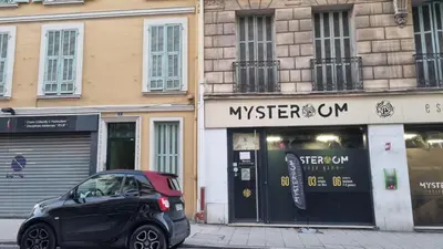 a bedroom with a bed and a kitchen with a counter at Studio l'Impérial- 3pers -Proche Centre et Plages in Nice