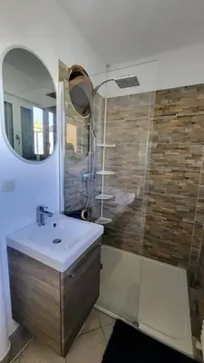 a kitchen and living room with a table and a couch at Romantic 1BR Escape with Sun-Rooftop Terrace in Nice