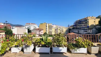 a balcony with a black cover on the floor at Romantic 1BR Escape with Sun-Rooftop Terrace in Nice