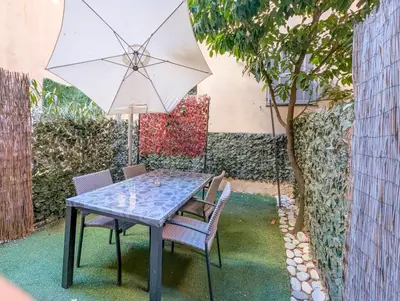 a table with two chairs and an umbrella at Chateau 4 Pers Vecchia Nizza AC WiFi in Nice