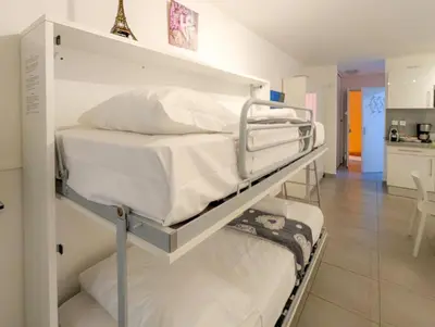 two bunk beds in a room with a kitchen at Chateau 4 Pers Vecchia Nizza AC WiFi in Nice