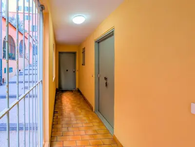 an empty hallway with orange walls and a glass door at Chateau 4 Pers Vecchia Nizza AC WiFi in Nice
