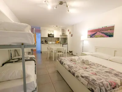 a bedroom with two bunk beds and a kitchen at Chateau 4 Pers Vecchia Nizza AC WiFi in Nice
