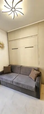 a couch in a living room with a ceiling at Studio Nice Plage Luxe in Nice