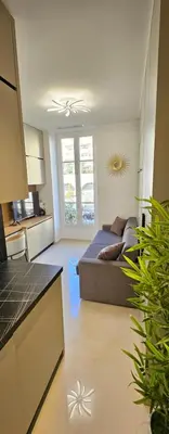 a living room with a bed and a kitchen at Studio Nice Plage Luxe in Nice