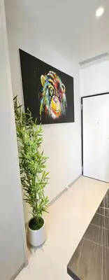 a room with a painting of a tiger on the wall at Studio Nice Plage Luxe in Nice