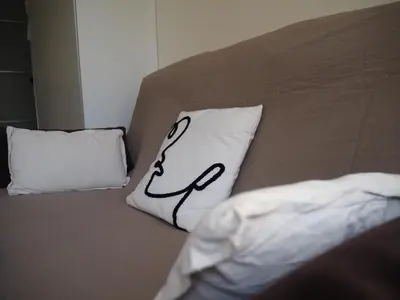 a bed with a pillow with a stethoscope on it at Studio with large terrace sea view 4th floor in Nice