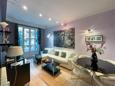 a living room with a white couch and a table at Comte De Nice 4Pers Parking Available WiFi AC in Nice