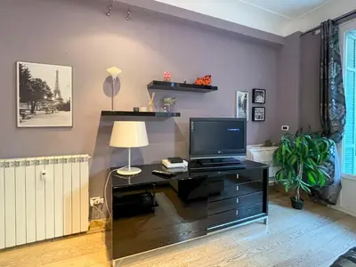 a living room with a desk with a television at Comte De Nice 4Pers Parking Available WiFi AC in Nice
