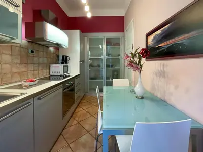 a kitchen with a blue table and white chairs at Comte De Nice 4Pers Parking Available WiFi AC in Nice