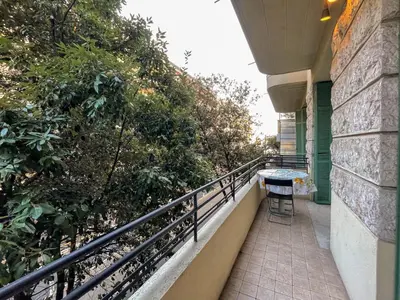a balcony of a house with a table and chairs at Comte De Nice 4Pers Parking Available WiFi AC in Nice