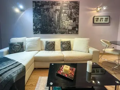 a living room with a white couch and a table at Comte De Nice 4Pers Parking Available WiFi AC in Nice
