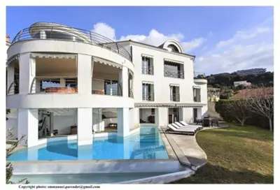 a large white house with a swimming pool in front of it at MONT BORON - NICE - Splendide villa d'architecte vue panoramique in Nice