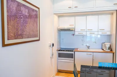 a kitchen with white cabinets and a sink at Promenade 2 Pers Vista Mare WiFi AC in Nice