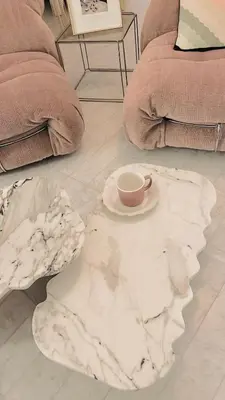 a coffee table with a cup on top of a marble floor at Penthouse avec terrasses panoramiques in Nice