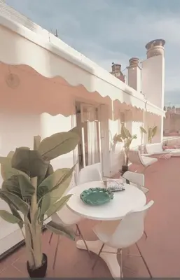 a white table and chairs on a balcony at Penthouse avec terrasses panoramiques in Nice