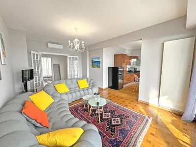a living room with a gray couch and yellow pillows at Cosy Cariatides Condo Promenade in Nice