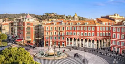 a city with a fountain in front of buildings at Stella Monte 2 AC WiFi 2 Pers in Nice