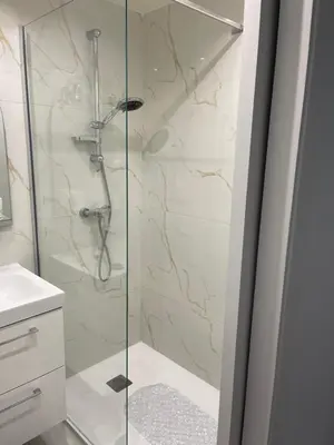 a shower with a glass door in a bathroom at Studio Lumineux à 2min de là plage in Nice