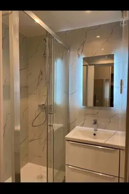 a bathroom with a glass shower and a sink at Studio Lumineux à 2min de là plage in Nice