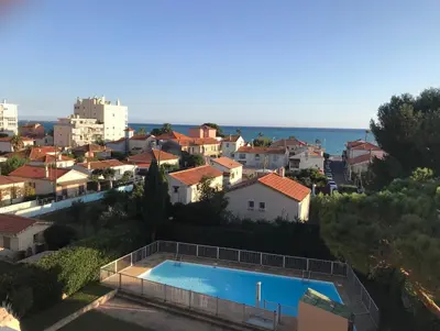 a villa with a swimming pool and a city at Le Pêcheur in Cagnes-sur-Mer