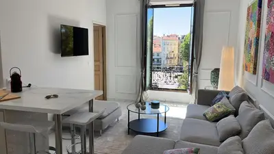 a living room with a couch and a table at Le Félix in Nice