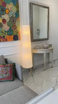 a living room with a table and a mirror at Le Félix in Nice