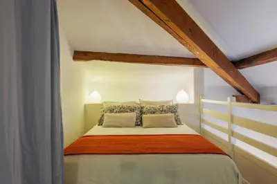 a bedroom with a bed in a attic at Jolie duplex avec patio in Nice