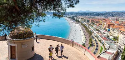 a group of people walking on a sidewalk next to the ocean at Massena 4 Pers Super Centrale WiFi AC in Nice