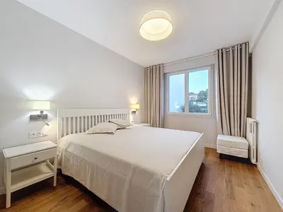 a white bedroom with a bed and a window at Seaview Promenade des Anglais 2brs apartment Parking cars 1800 kg max in Nice