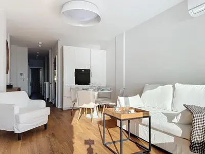 a living room with a white couch and a table at Seaview Promenade des Anglais 2brs apartment Parking cars 1800 kg max in Nice