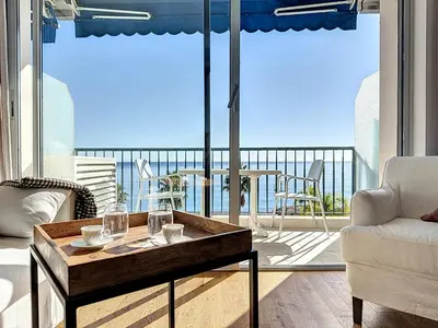 a living room with a table and a view of the ocean at Seaview Promenade des Anglais 2brs apartment Parking cars 1800 kg max in Nice