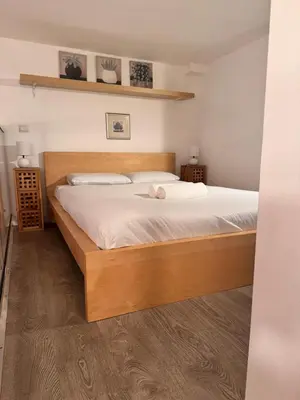 a bedroom with a large bed with white sheets at Tranquil Studio with Mezzanine in Carre dOr in Nice
