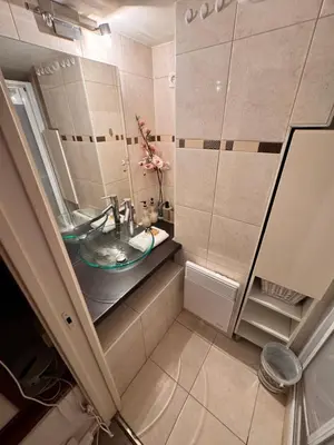a small bathroom with a sink and a mirror at Tranquil Studio with Mezzanine in Carre dOr in Nice