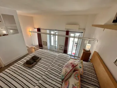a bedroom with a large bed with a mirror at Tranquil Studio with Mezzanine in Carre dOr in Nice