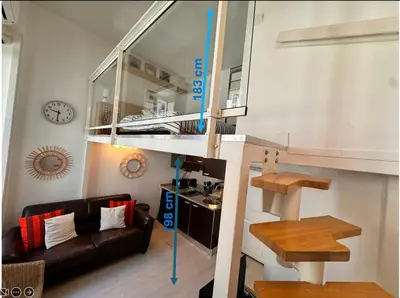 a living room with a loft bed and a couch at Tranquil Studio with Mezzanine in Carre dOr in Nice