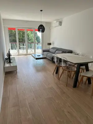 a living room with a couch and a table at 2 Bedroom Ocean view Apartment in Nice