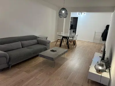 a living room with a couch and a table at 2 Bedroom Ocean view Apartment in Nice