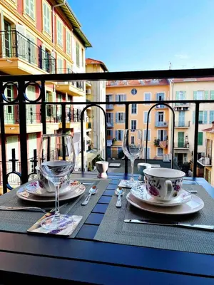 a table with two cups and saucers on a table at Flamingo Studio 2pax-WIFI-Nice Port in Nice