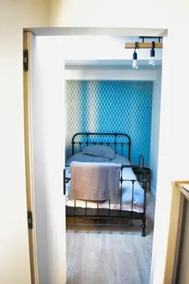 a dining room with a table and chairs and a clock at Enjoy old town side Nice-Modern apt-loft with AC in Nice