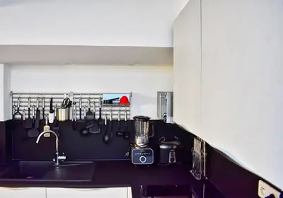 a bedroom with a black and white bed with a pink wall at Enjoy old town side Nice-Modern apt-loft with AC in Nice