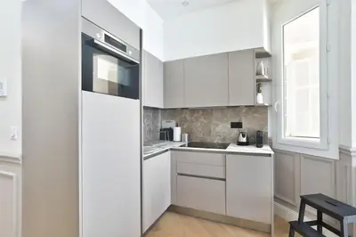 a white kitchen with white cabinets and a sink at #6 1BDR Buffa 2 min from the beach and Negresco,central AC Balcony in Nice