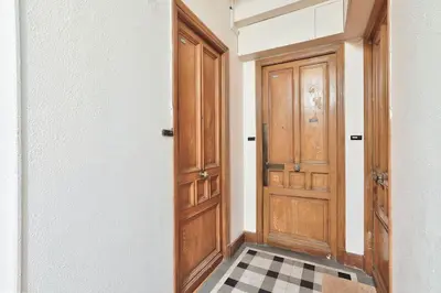 a hallway with a wooden door and a checkered floor at #6 1BDR Buffa 2 min from the beach and Negresco,central AC Balcony in Nice