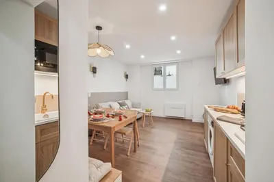 a kitchen and dining room with a table and a dining room at Lavie Maison Hot Tub and AC in Nice