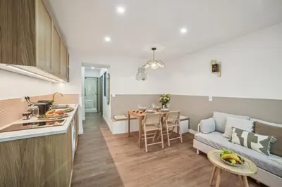 a kitchen and living room with a couch and a table at Lavie Maison Hot Tub and AC in Nice