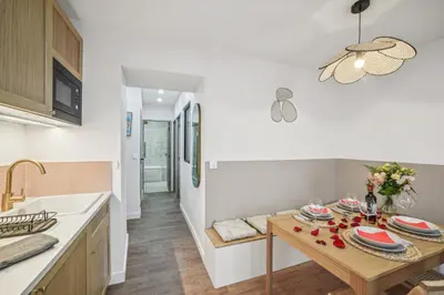 a kitchen with a wooden table and a dining room at Lavie Maison Hot Tub and AC in Nice